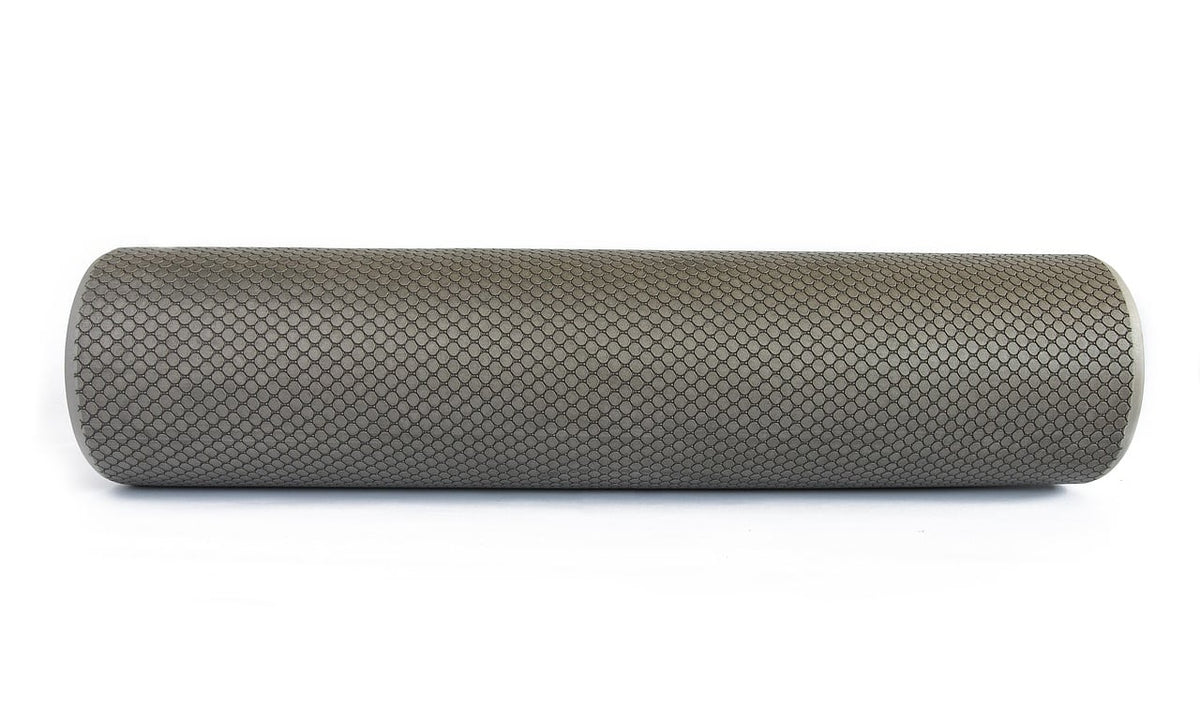 Gray textured foam roller lying on a white background